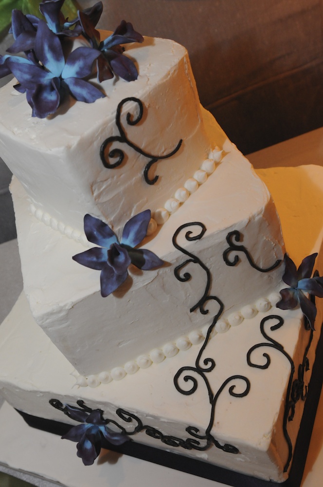 White Buttercream Wedding Cake with Orchids