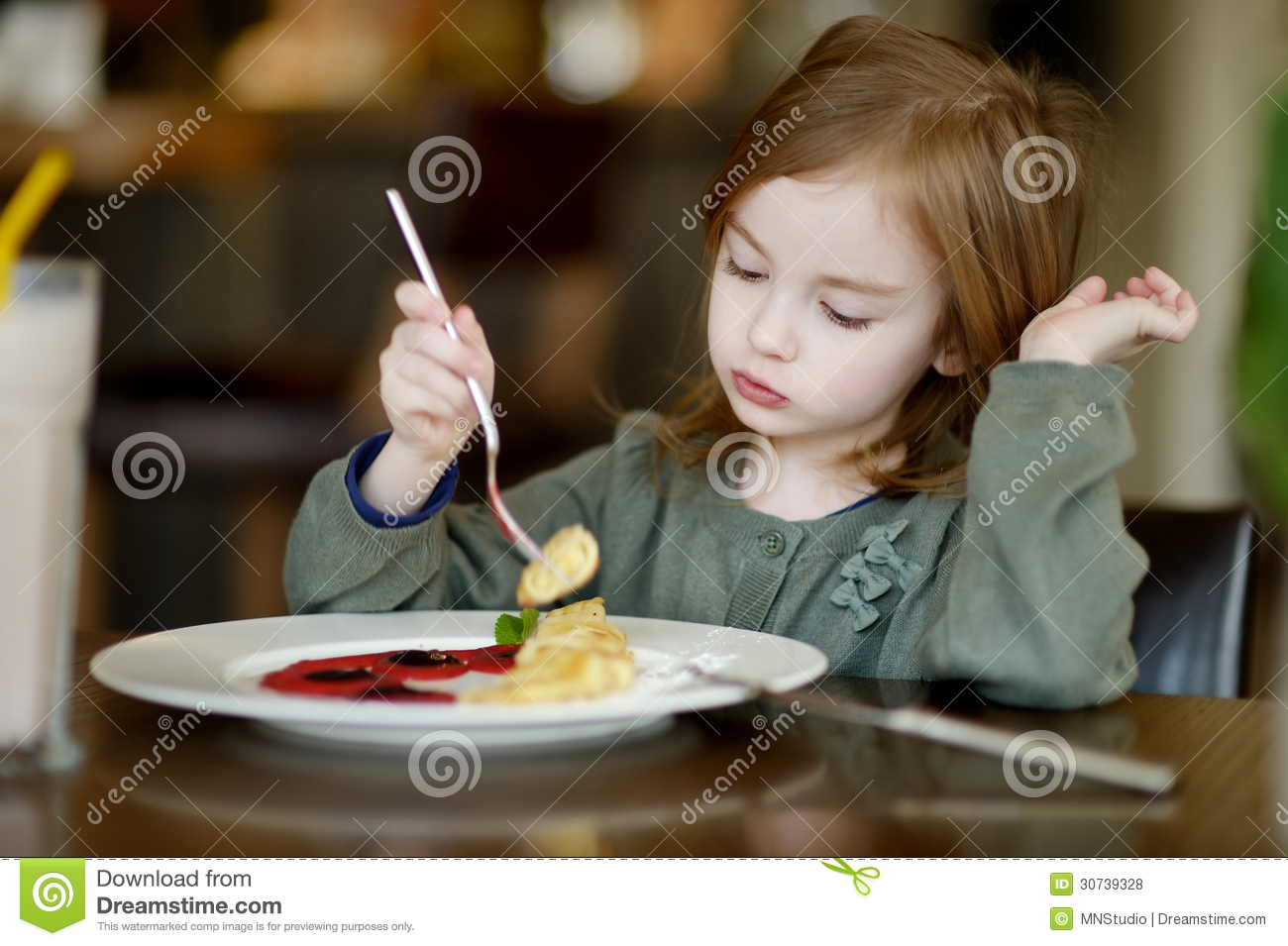 Little Girl Eating Pancakes