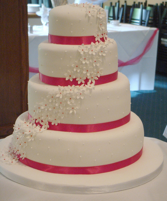 Wedding Cake with Ribbon and Pink Flowers