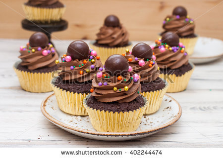 Cupcakes with Frosting and Chocolate Balls Gold