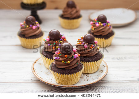 Cupcakes with Frosting and Chocolate Balls Gold